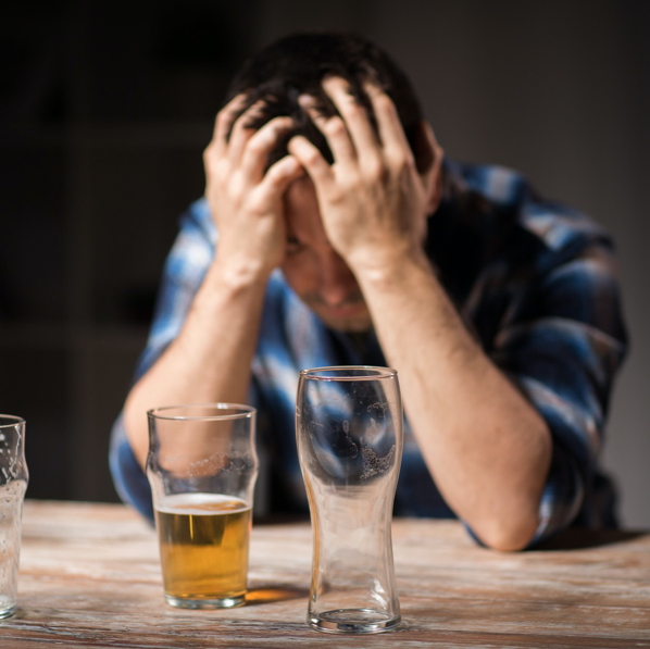 man feeling down about drinking beer