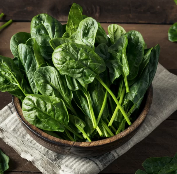 wooden bowl of raw spinach