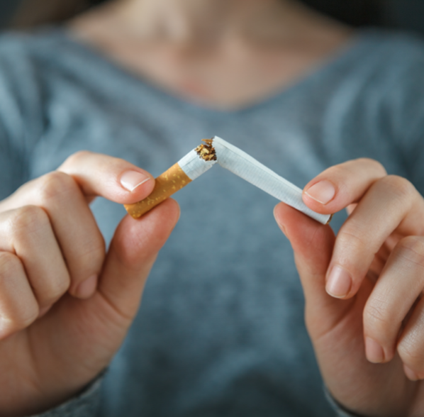 women breaking a cigarette