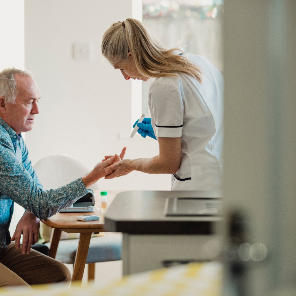 older man getting his finger pricked to check his glucose level