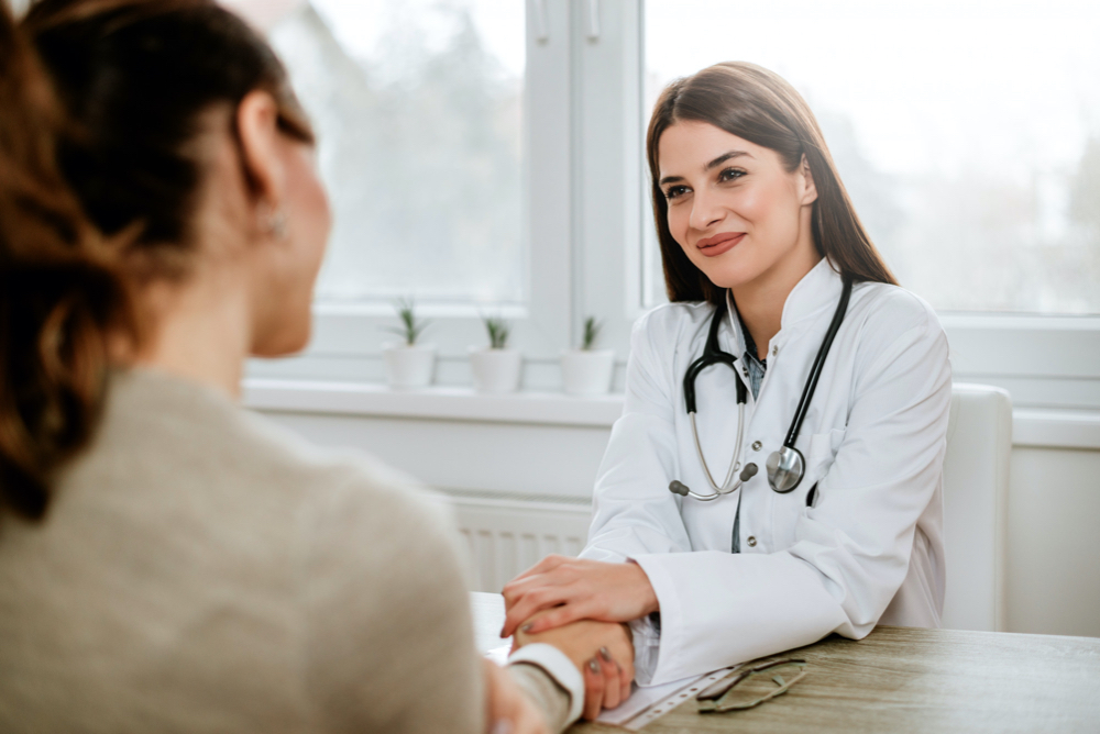 woman talking to attractive woman doctor