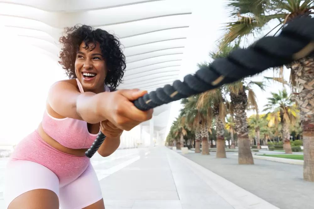 Sport training lifestyle and fitness concept portrait of beautiful happy african american woman exercising with jumping rope 