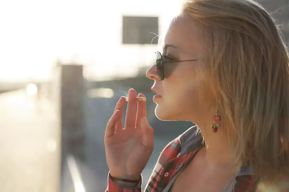 woman smoking cigarette outside