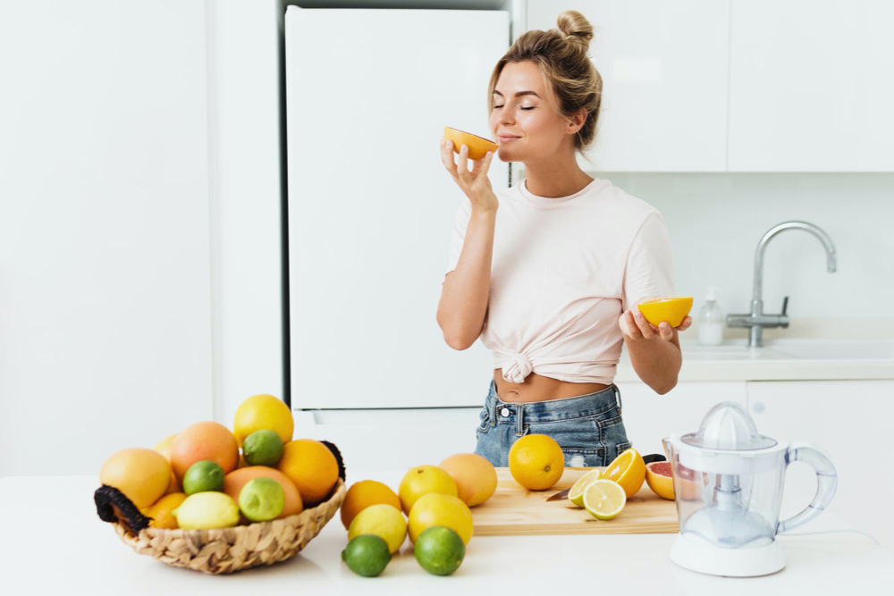 https://cdn.personalabs.com/wp-content/uploads/2023/05/beautiful-woman-sniffing-fresh-orange-during-citrus-juice-preparation-home.jpg