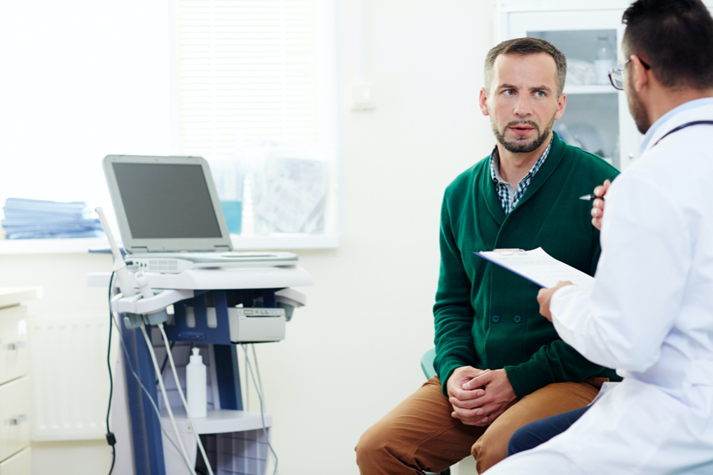 Free photo of concerned man listening to his doctor