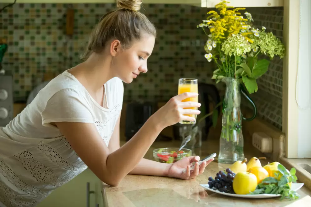 photo portrait of an attractive woman with juice and phone
