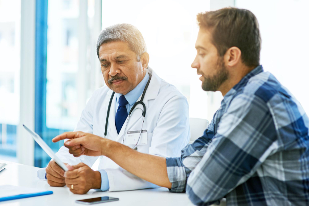 man talking with doctor about ordering lab tests online 