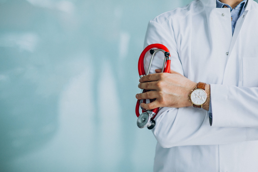 photo young handsome physician in a medical robe with stethoscope