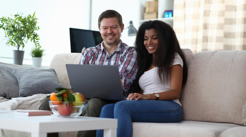 cheerful multinational couple at home