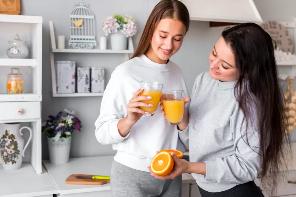 Cute women drinking orange juice
