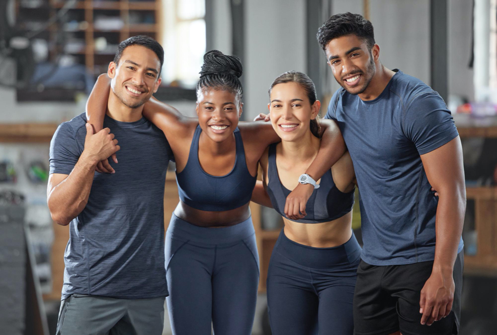 Photo fitness exercise and diverse accountability group standing together and looking happy after training at gym portrait of friends enjoying their membership at a health and wellness facility