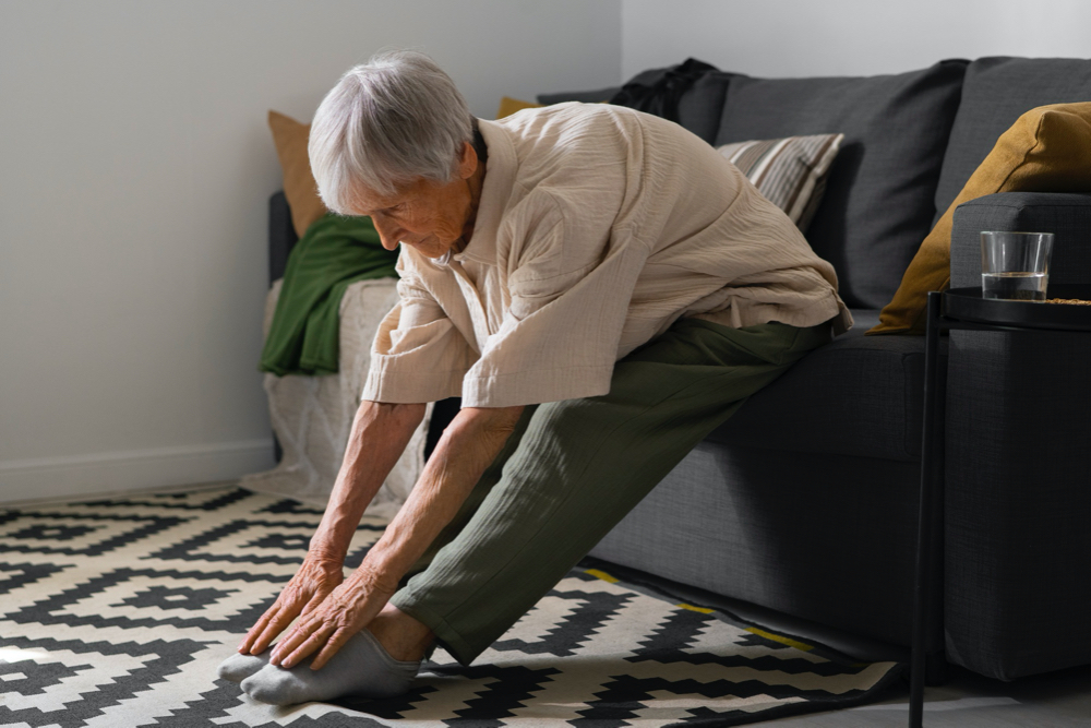 photo portrait of senior woman stretching at home