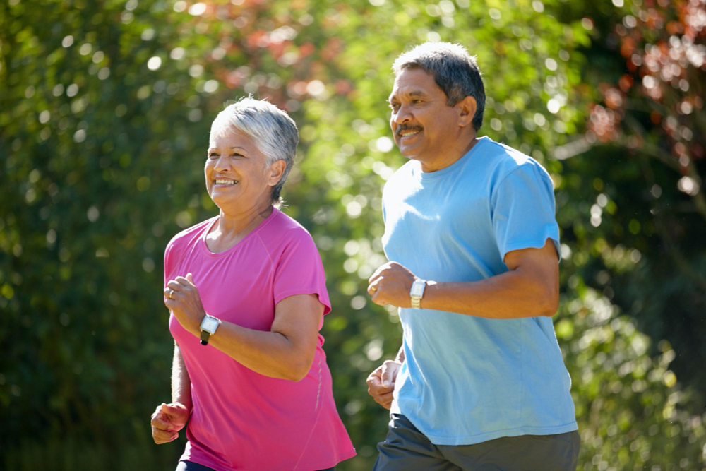 sunny day run shot of a mature couple jogging together on a sunny day