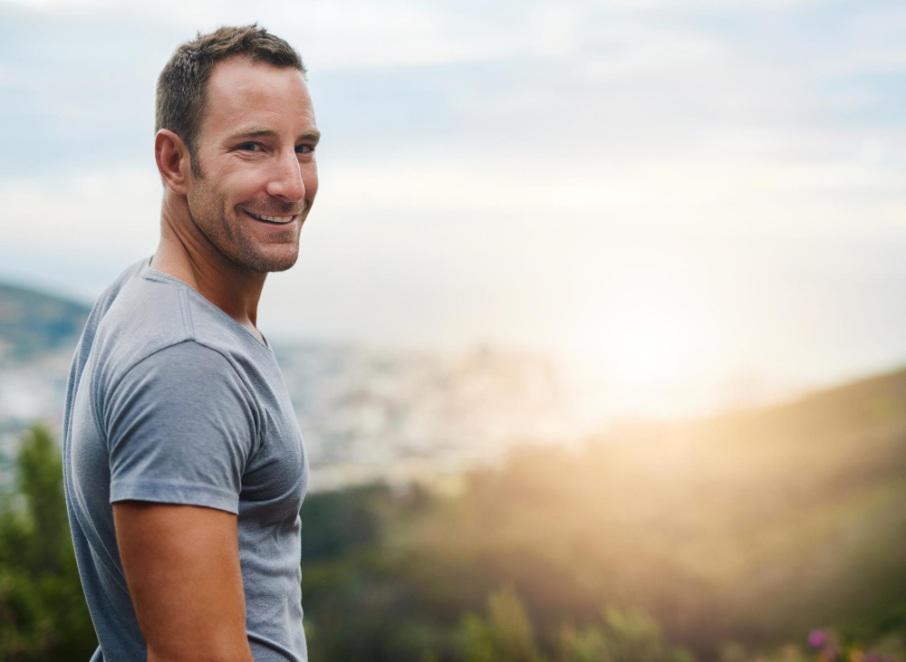 Portrait space or happy man in park nature or outdoor with confidence or freedom on holiday vacation Travel sunrise or person in summer natural environment or blue sky mockup to smile or relax
