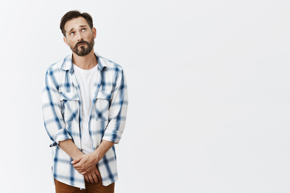 Insecure and shy bearded mature man posing having frequent urination