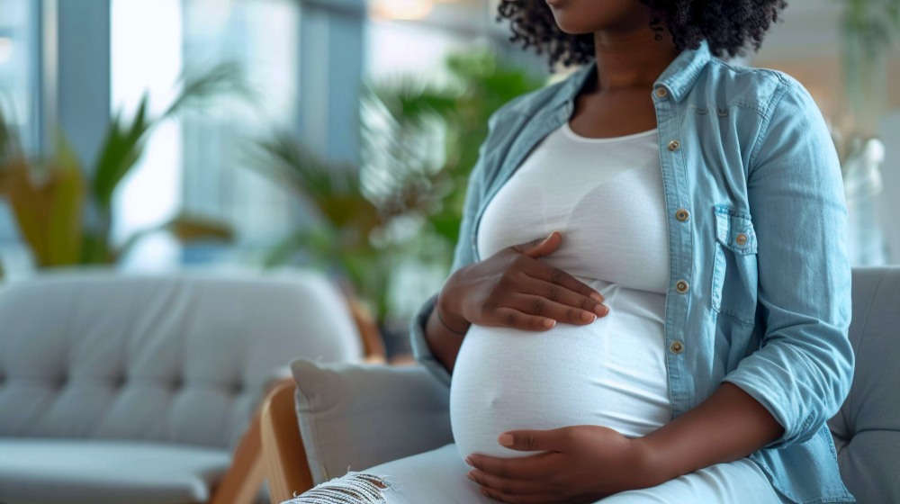 black pregnant woman posing in living room