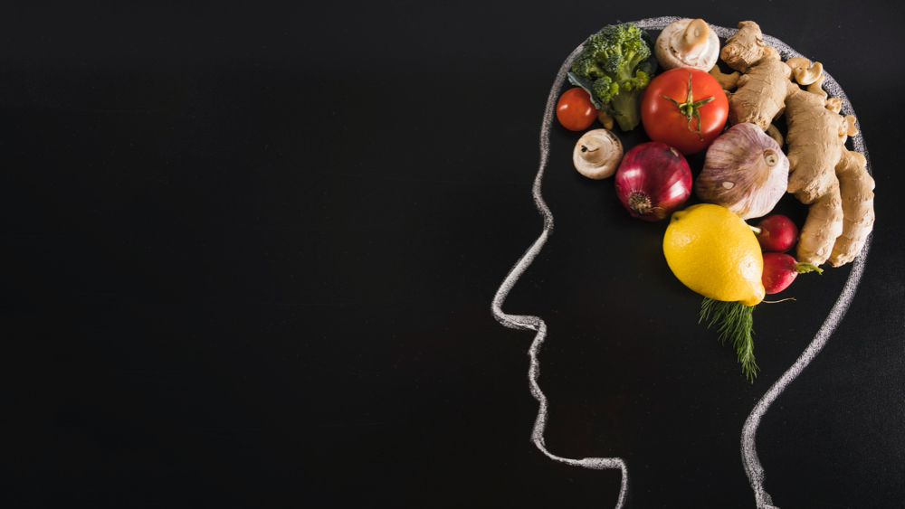 Chalk drawn human head with healthy food for brain on blackboard