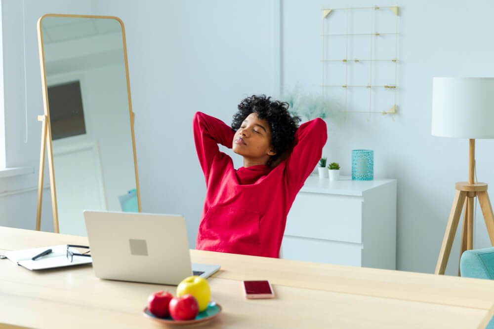 Side view of young woman using digital tablet in office
