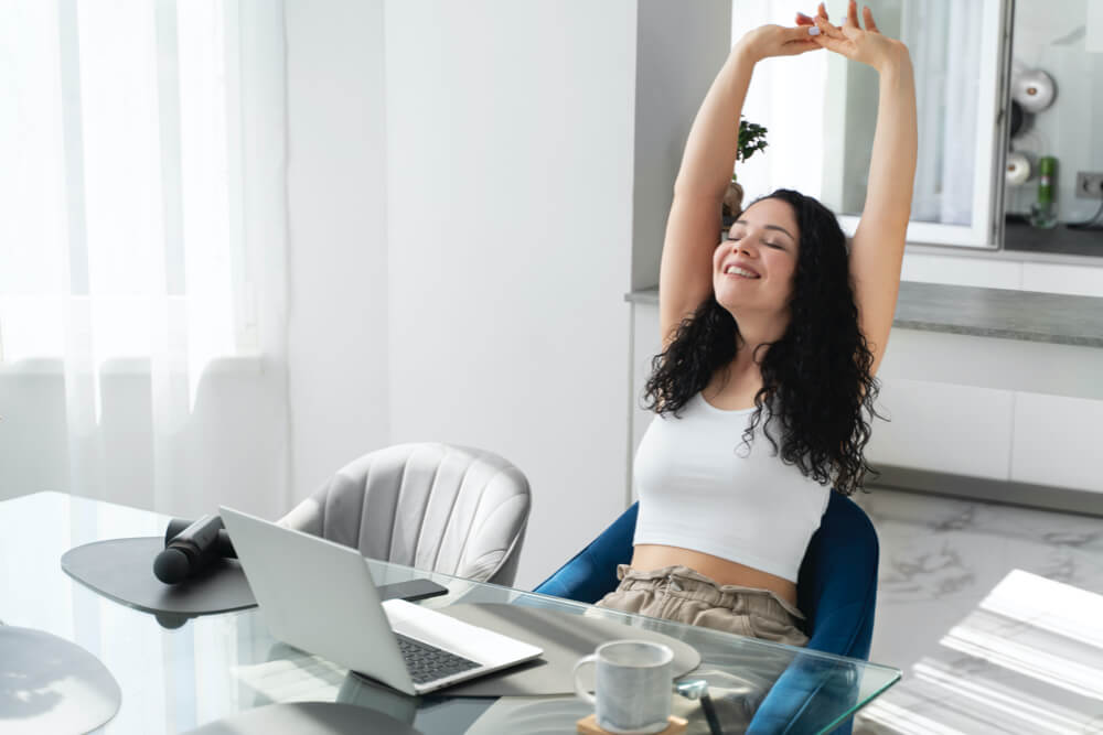 Medium shot woman stretching indoors
